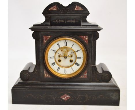 A late 19th century French black slate mantel clock with white enamel chapter ring set with Roman numerals housing an eight d