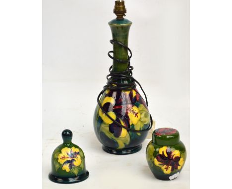 Three pieces of Moorcroft in the "Hibiscus" pattern on a green ground comprising a bell signed "William Moorcroft" and number
