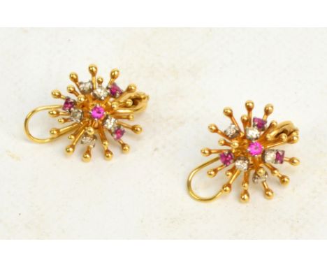 A pair of ruby and diamond starburst earrings set on unmarked yellow gold with safety backs, approx 11g.