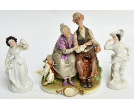 A Capodimonte figure group of an elderly couple seated on a brick wall with two cockerels beside, and a pair of Continental f