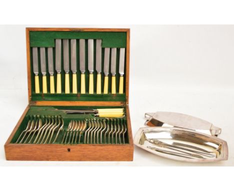 An oak cased canteen of electroplated cutlery comprising six dinner knives and six dessert knives with ivorine handles, six t