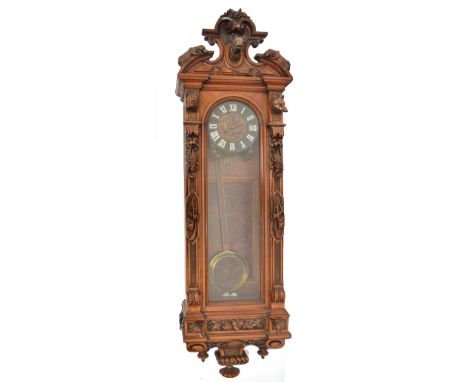 A large 19th century walnut Black Forest rectangular wall clock, the broken arch pediment carved with a stag flanked by a pai