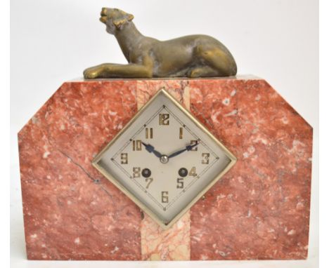 An Art Deco style French marble mantel clock with panther surmount above lozenge shaped silver dial set with Arabic numerals 