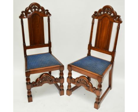 A pair of early 20th century walnut hall chairs in the 18th century manor with padded seat, shaped stretcher and baluster rin