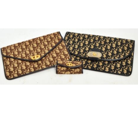 Two vintage Christian Dior leather lined clutch bags, 19 x 29cm and 19 x 25cm, also a matching key holder (3).