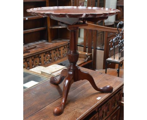 A reproduction mahogany tilt top tripod occasional table with birdcage action and piecrust rim, diameter 60cm.