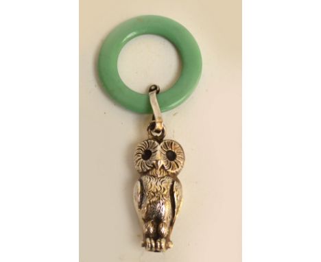 A George V hallmarked silver novelty rattle modelled as an owl suspended on turquoise plastic teether ring, maker WA, Birming