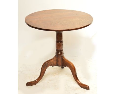 An oak occasional table with circular top on turned column and tripod supports, width 66cm.