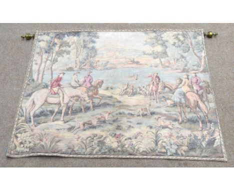 A decorative woven tapestry of a hunting scene with dogs in wooden countryside with mountainous scene behind, 92 x 115cm, wit