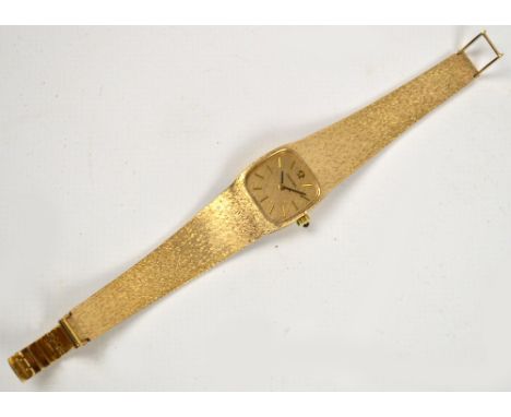 OMEGA; a 9ct gold lady's mechanical wristwatch with rounded rectangular dial set with baton numerals on integrated 9ct gold t