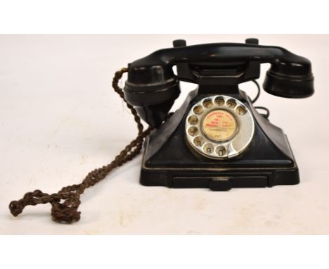 A vintage black telephone with rotary dial, length of handle 23cm. CONDITION REPORT: The left hand arm where the receiver res