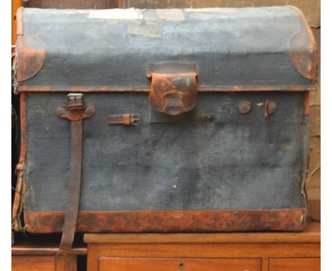 A large vintage leather and canvas domed travelling trunk.