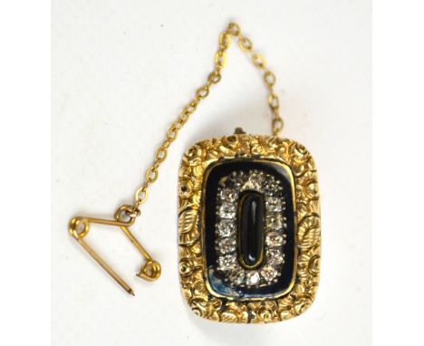 A 19th century yellow metal mourning brooch of rectangular form, set with elongated cabochon with border of old cut diamonds 