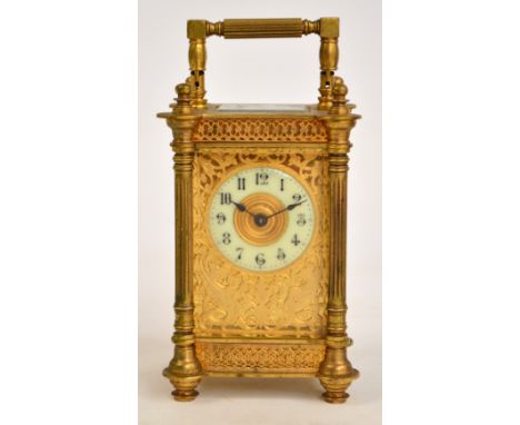A late 19th century French brass and champlevé enamel decorated carriage clock, with pierced and engraved rectangular dial de