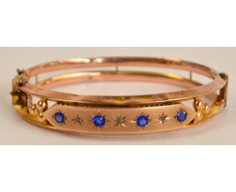 A 9ct rose gold Victorian snap bangle, set with four blue stones alternating three diamond chips, with a safety chain, 11.5g.