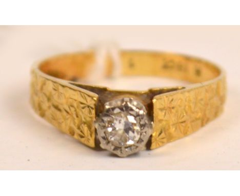 An 18ct gold single stone diamond ring, the diamond weighing approx 0.10ct within a floral engraved band, size N 1/2.