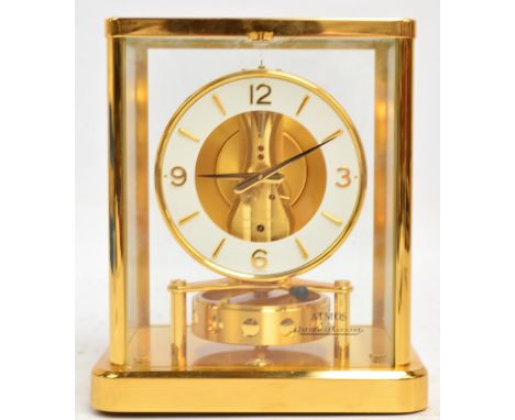 A 1980s Jaeger LeCoultre brass cased Atmos clock with circular chapter ring set with baton and Arabic numerals, no.540, heigh