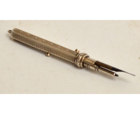 An Edward VII hallmarked silver pencil/dipping pen combination of hexagonal form with two sliders, with overall engine turned