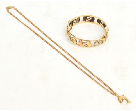 A 9ct three tone gold snap bangle decorated with dolphins and a matched pendant suspended on 9ct yellow gold flat link chain,