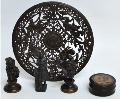 A cast iron circular dish with pierced decoration depicting four mythological marine figures amongst foliate and floral scrol