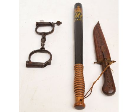 A Victorian truncheon painted with the VR insignia and "C. of Lw", length 49cm, a pair of 19th century handcuffs, and a knife