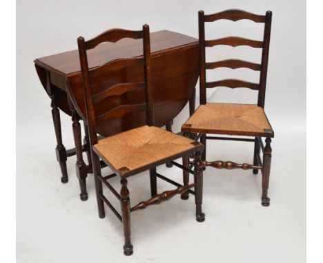 An oak gateleg dropleaf dining table and a set of four rush seated ladder back chairs (5).