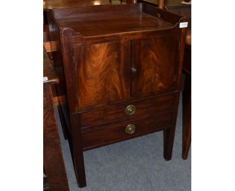 A George III mahogany tray top bedside commode, late 18th century, with two cupboard doors above a two-as-one drawer sliding 