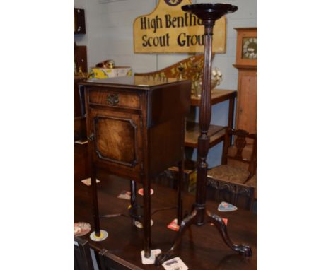 A mahogany drop leaf pot cupboard with shelf stretcher; together with a mahogany torchere of slender form, 107cm high 