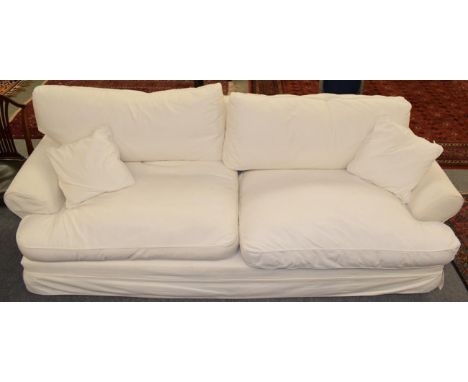 A large four seater white linen upholstered feather filled sofa, 260cm long 