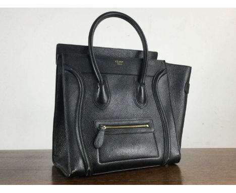 CELINE OF PARIS, BLACK LEATHER HANDBAG, with interior zipped compartments31cm wideCondition good to fair. Wear commensurate w