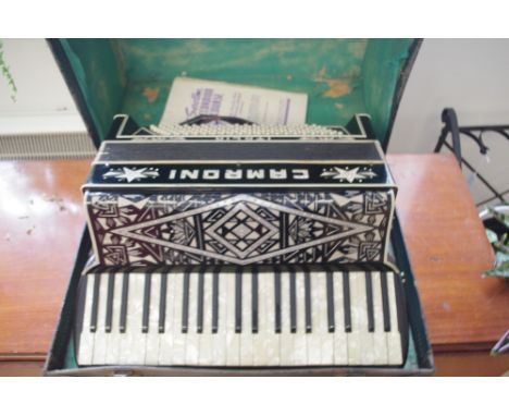 An Italian piano accordion by Camroni, in black and simulated mother-of-pearl, inset with rhinestones, with carrying case.