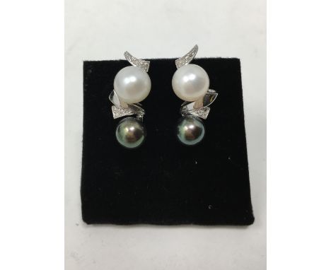 A pair of 18ct white gold South Sea pearl and diamond earrings, each earring set with a black and white pearl.