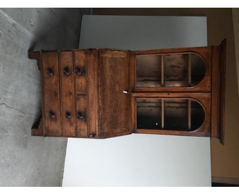 A 19th Century oak glazed bureau book case, the upper glazed doors to rising shelves above a fall front with fitted interior,