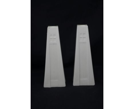 A pair of Belleek ceramic tower candlesticks.