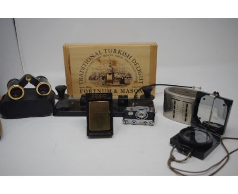 A box of mixed collectables including pens, miniature binoculars, money boxes, a lighter in the form of a camera stamped K.K.