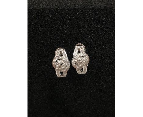 A pair of 14ct white gold and diamond encrusted earrings.