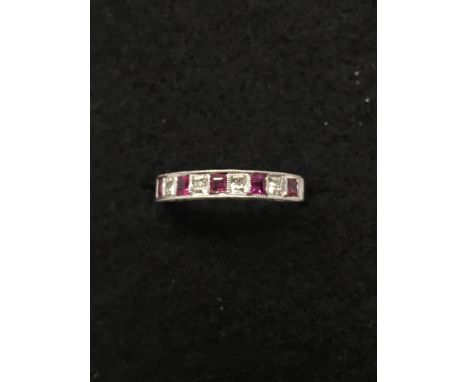 An 18ct white gold, ruby and diamond half eternity ring, size K/L.