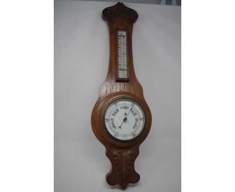 A 1930s oak banjo barometer with thermometer.