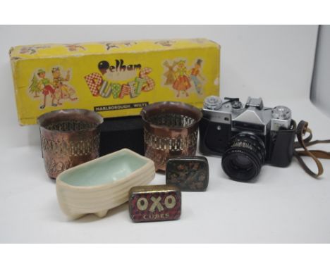 A box of mixed collectables including two mother of pearl shells, a Pelham puppet, cameras, two Arts and Crafts pierced minia