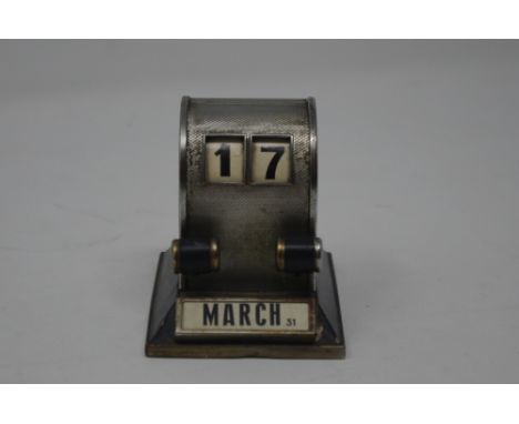 An Art Deco desk top calendar with engine turned decoration (one month slide missing September - October).