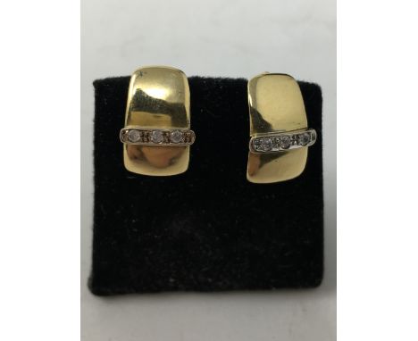 A pair of 18ct gold and diamond set earrings, each earring set with three diamonds, total weight approximately 4.2 grams.