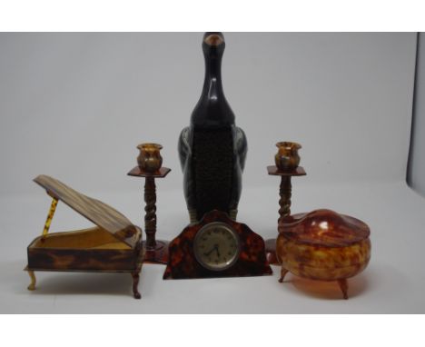 A faux tortoiseshell dressing table set including a bedside clock and a plastic clothes brush in the form of a duck.