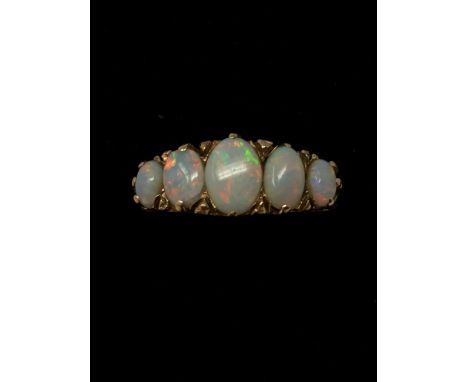 A 9ct gold five stone opal ring the opals set in a Victorian style setting.