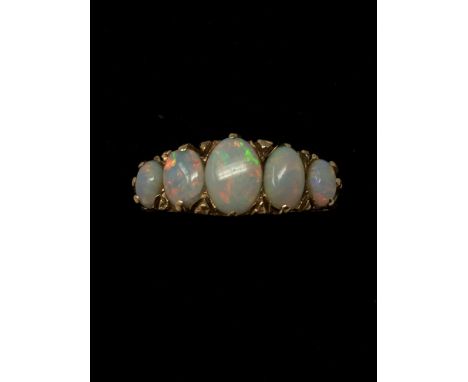 A 9ct gold five stone opal ring the opals set in a Victorian style setting.