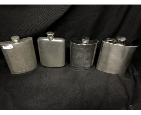 Four assorted hip flasks including a boxed Celtic hip flask, unused.