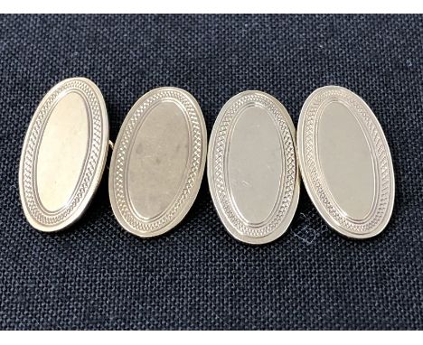 A pair of 9ct gold cufflinks with engine turned decoration. Approximate weight 6.3 grams.