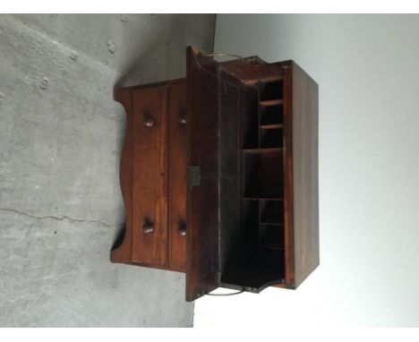 A Victorian mahogany secretaire chest, the secretaire with fitted interior above three long drawers, raised on shaped bracket