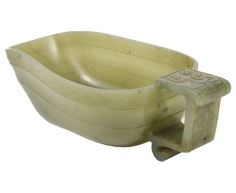 A CHINESE JADE LIBATION CUP, 19TH CENTURY of boat-like form, the rim with key border above a concave band, the angular handle