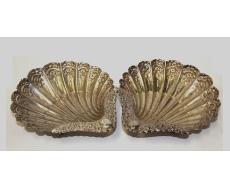 A PAIR OF VICTORIAN SILVER SHELL DISHES, ATKIN BROTHERS LTD., SHEFFIELD, 1891 richly chased, each on three whelk supports, 14