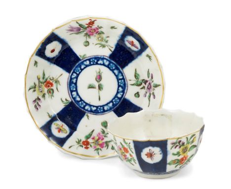 A WORCESTER POLYCHROME TEABOWL AND SAUCER, CIRCA 1770 fluted, painted with panels of flowers alternating with blue panels res